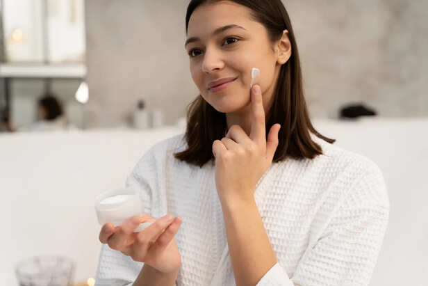 Woman Applying Lightweight Moisturiser