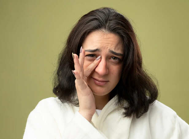 Person rubbing tired eyes after long screen exposure
