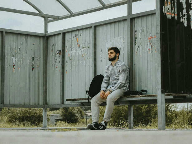Young Adult Sitting Alone in a Public Space