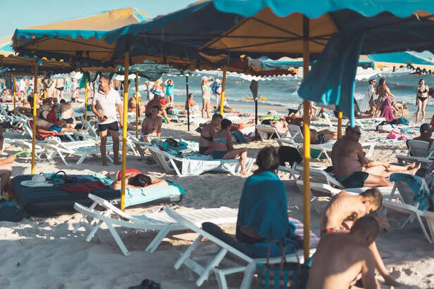 People Sunbathing During Peak Afternoon Hours