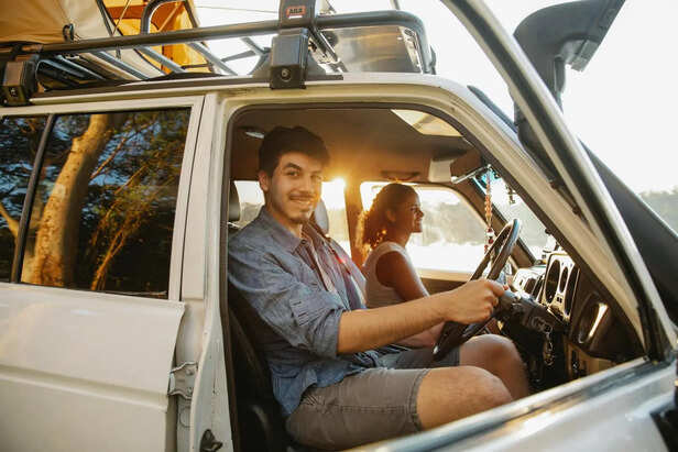Young Travellers Packing a Car for a Road Trip
