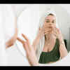 Young Adult Looking Frustrated at Mirror During Skincare Routine