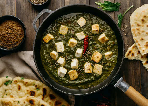 Paneer curry served beside a bowl of dal Imag