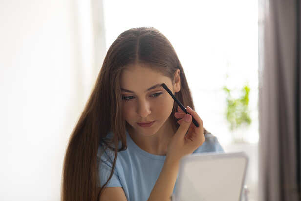 Browing her eyebrows