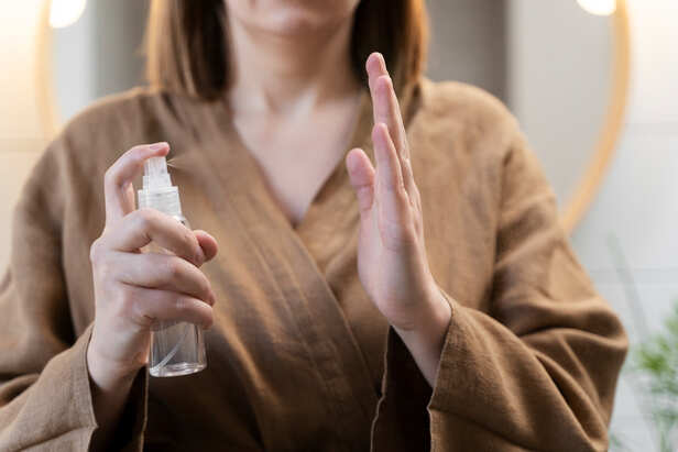 Applying body lotion before spraying perfume