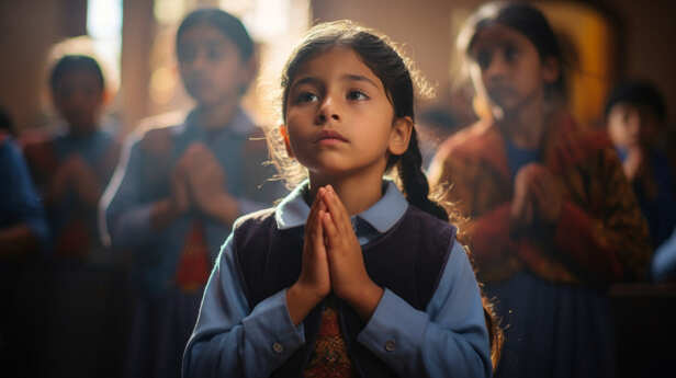 Child Praying to Lord Ganesha Before Studies