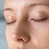 Person Looking at Oily Skin During Monsoon