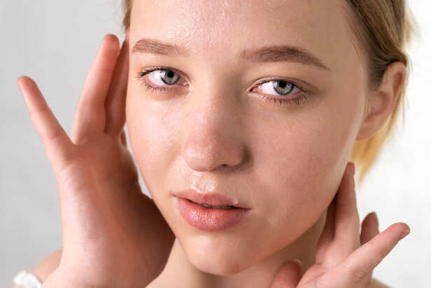 Person Overwashing Face in Front of Mirror
