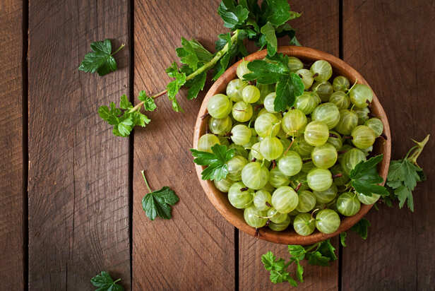 Fresh amla fruits with herbal hair oil