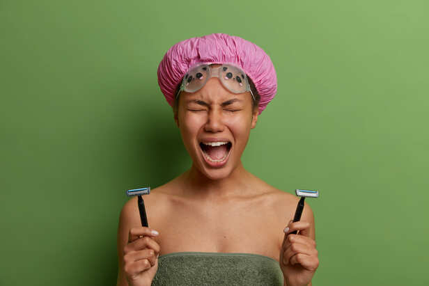 Woman using a facial razor for grooming