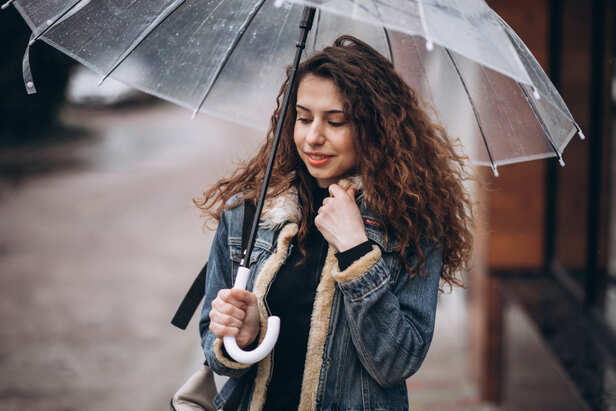 Woman Standing Outdoors During Rainy Weather