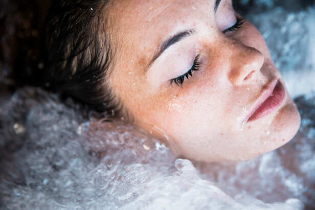 Woman Splashing Cold Water on Her Face