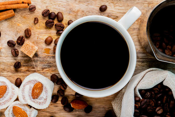 Cup of Black Coffee Beside Fitness Equipment
