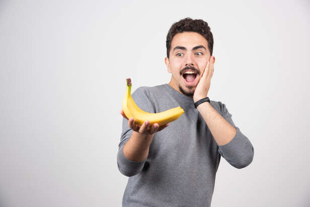 Person enjoying a banana before a workout