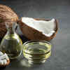 Coconut oil in a glass bowl with fresh coconuts