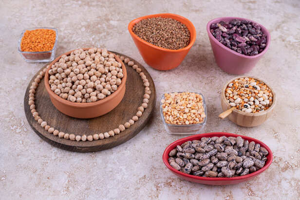 Mixed beans, lentils and chickpeas in wooden bowls