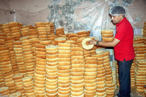 A worker arranges the Ghewars at a sweet shop