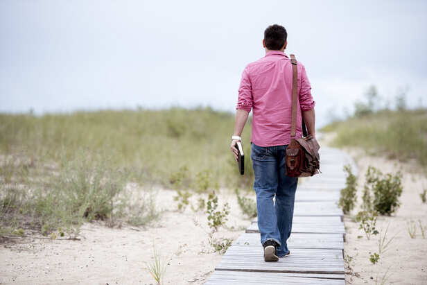 Person standing alone while others walk away
