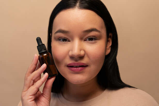 Applying facial oil to hydrated skin