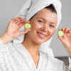 Fresh cucumber slices and lemon beside a glass bowl