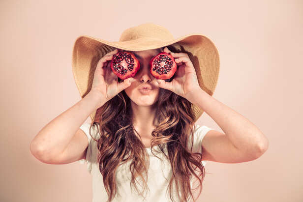 Fresh pomegranate with glowing ruby-red seeds