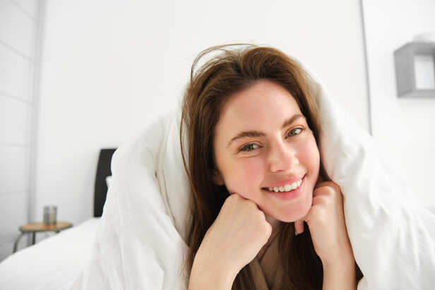 Person waking up naturally with a smile