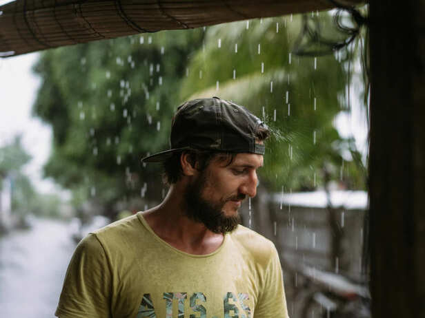 Person Changing Wet Clothes After Rain