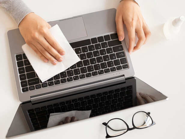 Cotton Swab Cleaning Dust Around Laptop Keys