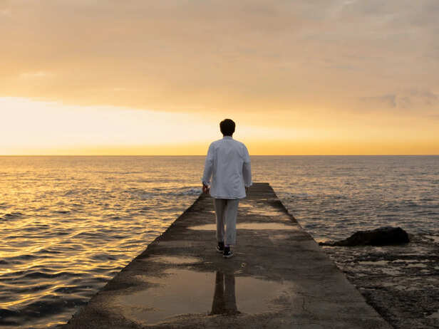 Person Looking Toward a Bright Horizon