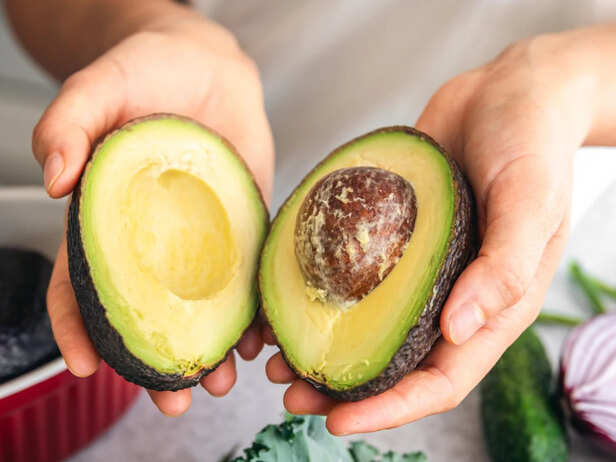 Fresh avocado halves on a healthy breakfast plate