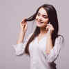 Woman checking hair strands after brushing