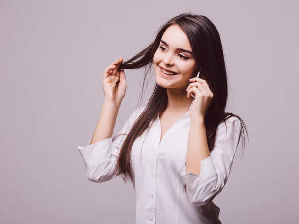 Woman checking hair strands after brushing