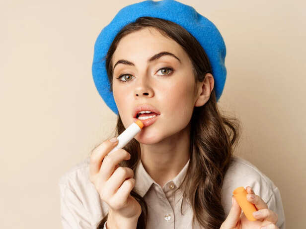 Woman applying moisturising lip balm