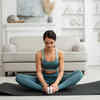 Woman performing Butterfly Pose on a yoga mat