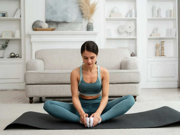 Woman performing Butterfly Pose on a yoga mat