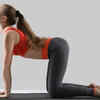 Woman moving through Cat-Cow yoga pose