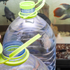 Remove a portion of the old water and replace it with appropriately treated water while maintaining stable conditions.
