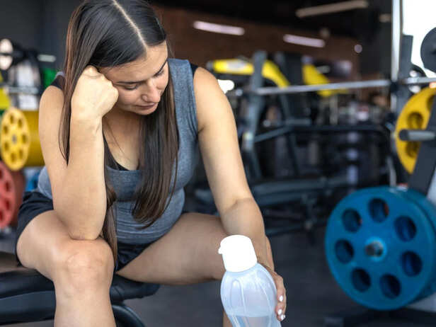 Tired athlete struggling during gym workout