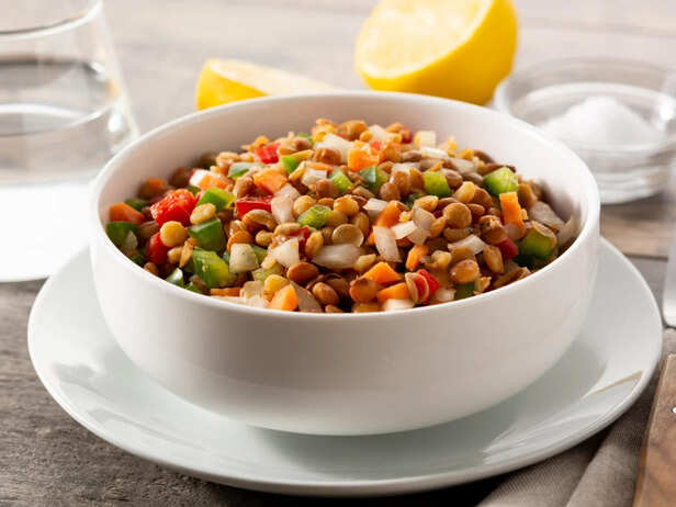 Bowl of cooked lentils with vegetables