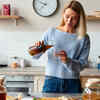 Woman preparing a homemade hair growth drink in a kitchen