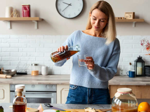 Woman preparing a homemade hair growth drink in a kitchen