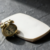 Brass clock, blank notebook