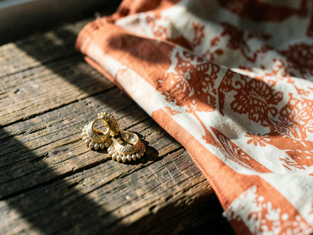 Golden Jhumkas on Teak